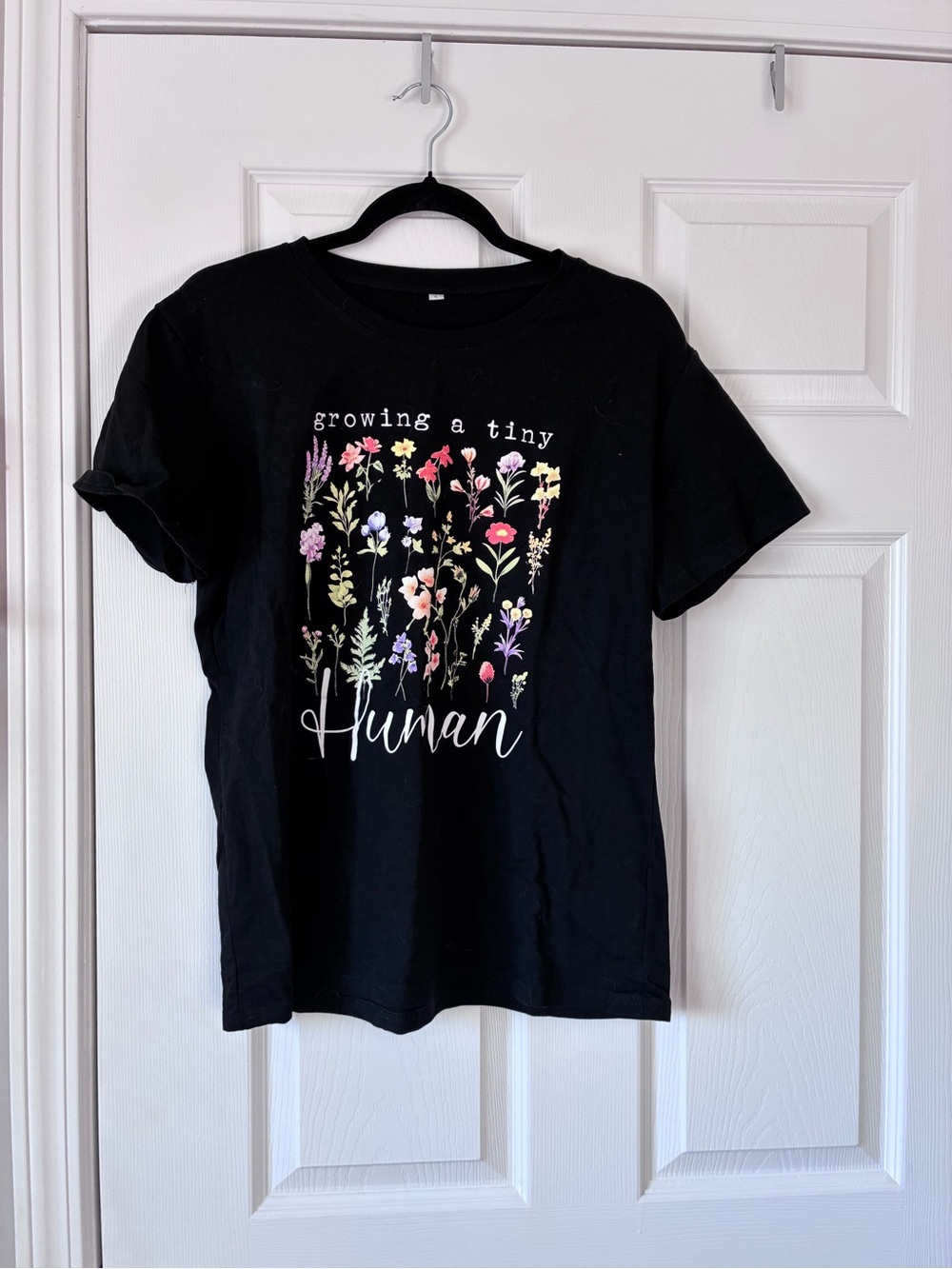 Source Unknown Black Tee with Colorful Floral 'Growing a Tiny Human' Graphic